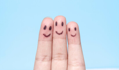 Three fingers with happy faces drawn like family or friends, fingers with smiling emojis, fingers...