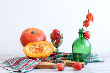 Orange pumpkins on a kitchen napkin next to glassware