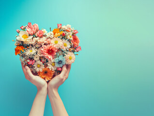 Women's hands hold a bouquet of flowers in the shape of a heart. Valentine's day natural love concept
