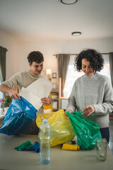 mother and son recycle at home sorting waste plastic paper and glass
