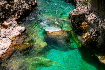 Cascade and current of Soča (Emerald River) in Slovenia, pristine wild alpine river with crystal...