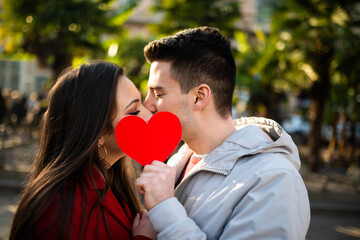 Romantic couple holding red heart