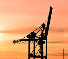 Container crane in Rotterdam harbour by sunset