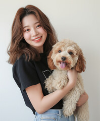 Pretty Korean woman with a cute smiling labradoodle puppy