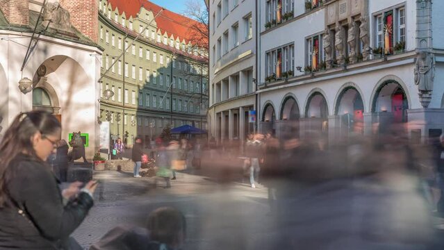 Kaufingerstrasse, shopping street and pedestrian zone in Munich downtown near the Marienplatz timelapse. Historic buildings with people walking around. Entrance to a museum. Bavaria, Germany