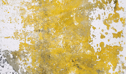 Old rough concrete background with white and yellow cracked paint. Grunge wall texture. Concrete wall surface with cracked paint. Close up.
