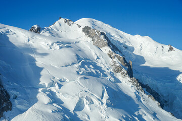 Naklejka premium Beautiful Mont Blanc summit, highest mountain in Western Europe view on sunny day, popular mountaineers climbers mountain, Chamonix, france