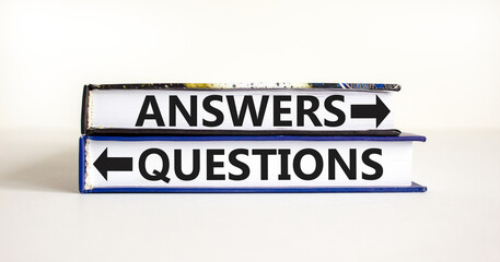 Questions and answers symbol. Concept word Questions Answers on beautiful books. Beautiful white table white background. Business questions and answers concept. Copy space.