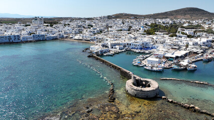 Aerial drone photo from picturesque small seaside village of Naoussa with traditional Cycladic...