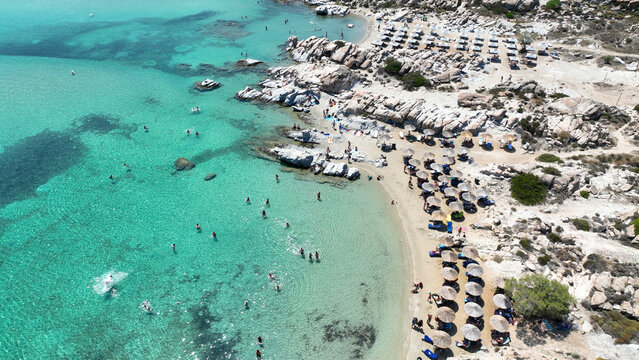 Aerial drone photo of famous small organised beach with unique rock formations of Kolimbithres or Kolympithres in the gulf of Naousa, Paros island, Cyclades, Greece