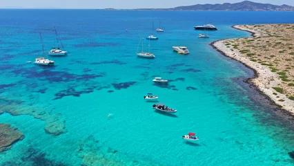 Deurstickers Aerial drone photo from tropical exotic paradise secluded rocky island bay with deep turquoise and sapphire sea forming a blue lagoon visited by yachts and sailboats in Caribbean exotic destina © aerial-drone