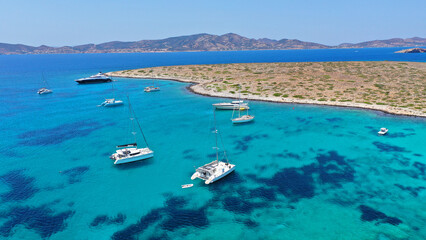 Aerial drone photo of azure paradise blue lagoon of Panteronisi a small islet complex between Paros and Antiparos islands visited by yachts and sail boats, Cyclades, Greece