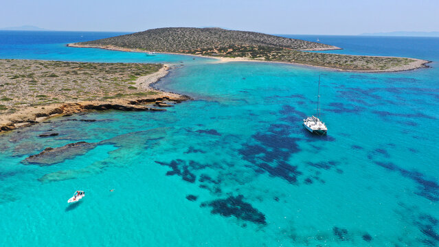 Aerial drone photo of azure paradise blue lagoon of Panteronisi a small islet complex between Paros and Antiparos islands visited by yachts and sail boats, Cyclades, Greece