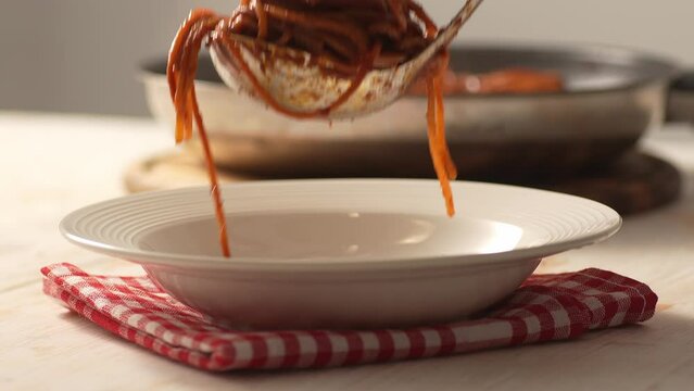 Serving Pasta with Tomato Sauce. Step of Recipe Fried Assassin's Spaghetti Cooking. Close-up, shallow dof.