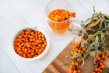 Clear teapot with sea buckthorn tea, a medley of flavors and health benefits.
