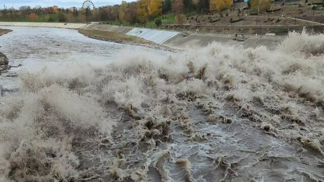 Spillway in Maykop dam, dirty water in river