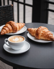 Morning Coffee and Croissant in a Cozy City