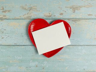 Heart shaped plate and paper card on vintage wooden background. Top view. - 728760515
