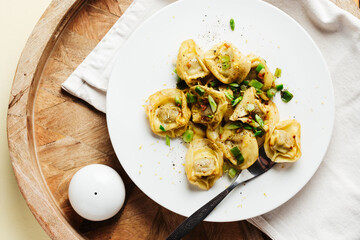 Mushroom tortellini with butter and herbs.