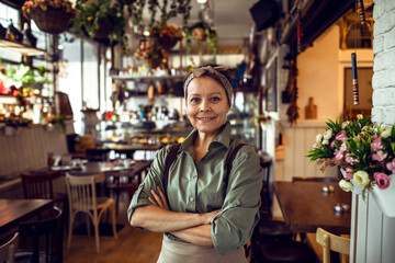 Portrait of a middle aged waitress in a restaurant
