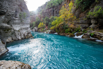 Fototapeta premium Transparent waters of Kopru River (Köprüçay, ancient Eurymedon) with its emerald green colour in Koprulu Canyon (Köprülü Kanyon) National Park, Antalya, Turkey. It's a rafting paradise