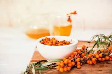 Clear teapot with sea buckthorn tea, a medley of flavors and health benefits.