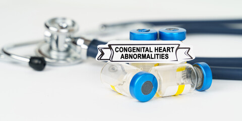On the table there is a stethoscope, injections and a sign with the inscription - congenital heart abnormalities