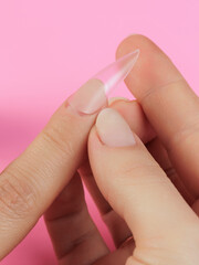 Step-by-step instructions for nail extension on gel tips. Manicure, hands in the foreground. Pink background. Copy space
