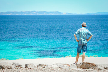 A happy guy near the sea in nature weekend travel