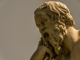 Socrates bust marble statue, the ancient Greek philosopher in deep thoughts, isolated on plain sky...