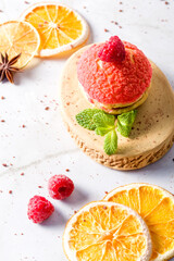 Shu cake. Custard dessert with creamy white cream, decorated with raspberries