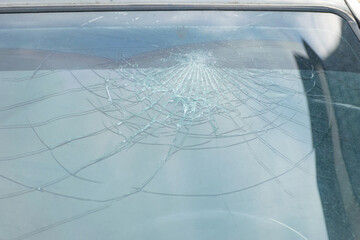 broken car windshield. a crack in the glass after an accident or a stone hit. close-up