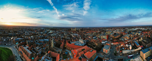 Panoramic aerial view of a cityscape at dusk with historic buildings and a dramatic sky in York, North Yorkshire
