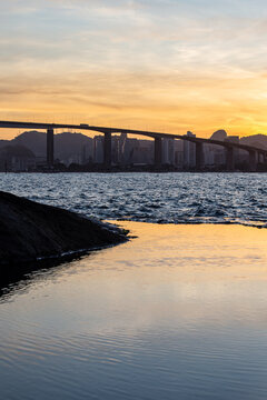 View of the third bridge, which connects the cities of Vila Velha and Vit&oacute;ria during a late afternoon with colorful sky reflected in the natural pool