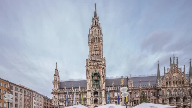 Marienplazt Old Town Square with the New Town Hall timelapse hyperlapse. Neues Rathaus and Town Hall Clock Tower Glockenspiel. Munich skyline, downtown cityscape with cloudy sky. Bavaria, Germany