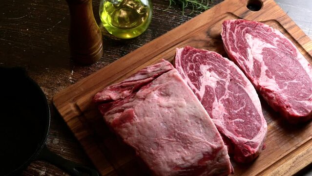 chunk of ribeye steak on wooden board