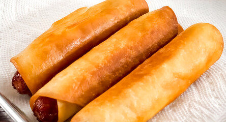 Hot Dog Grilled Fried Mexican with tortilla, close up. Hot dog freshly baked on plate, homemade. Grocery product advertising, menu or package, selective focus.