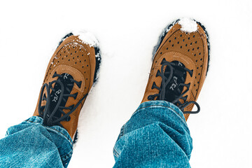 Close up of men’s work boots standing in the snow