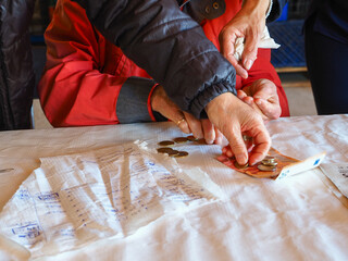 different hands checking accounts and handling money