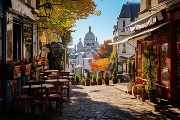 Fototapeta premium Cobblestone street with tables and chairs.