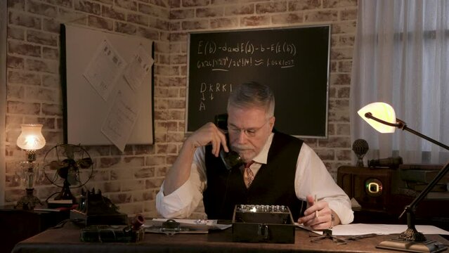 Enigma scientist answering the phone while working