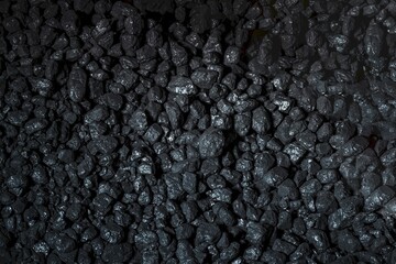 Heaps of coal. Natural black coals for house heating. Industrial fossil coal.