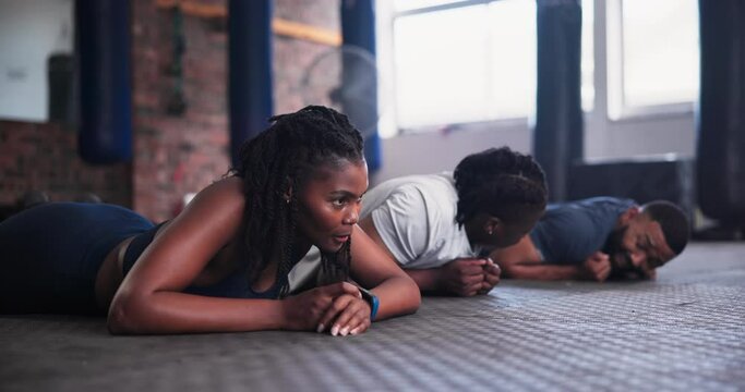 People, plank and fitness on floor at gym for workout, core exercise or abdominal training together. Active group in practice, endurance or stamina for ab muscles or strong balance at health club