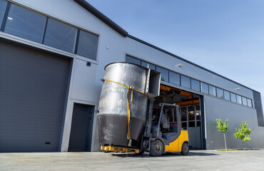 Forklift loading goods into truck outside warehouse
