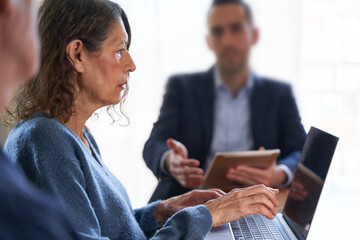 Misoginy and ageism in business. Mature female scolded by young male boss 