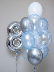silver number 8 and set of blue helium balloons on white background