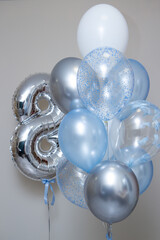 silver number 8 and set of blue helium balloons on white background