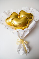 golden heart with ribbon on white