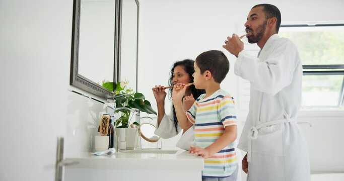Father, learning or children in bathroom brushing teeth together for development in morning at family home. Young siblings, dad or kids cleaning mouth with toothbrush or toothpaste for dental health