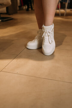 The image shows a persons legs wearing white shoes 6080.